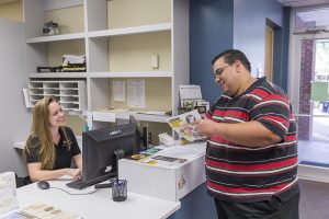 SAS front desk receptionist welcoming a student